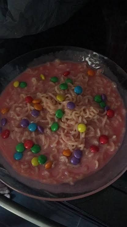 a bowl filled with cereal and candy on top of a stove