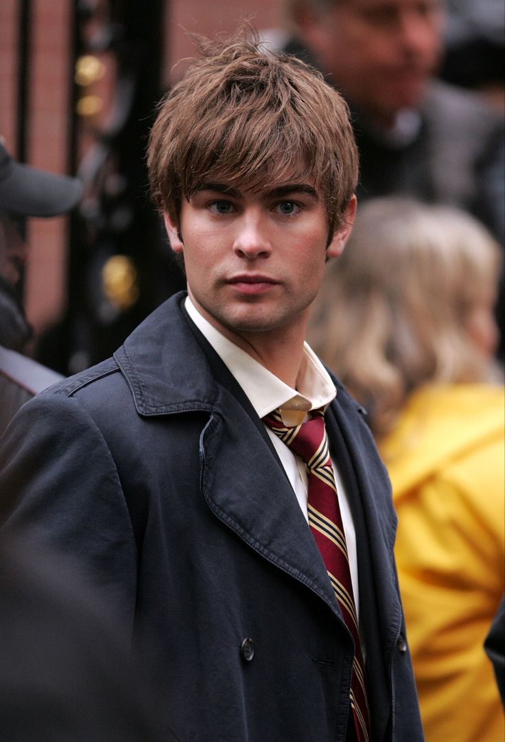 a young man in a trench coat and tie on the set of harry potters