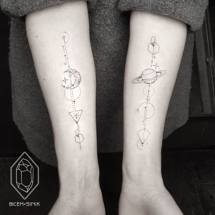 two people with matching tattoos on their legs, one has a saturn and the other has a star