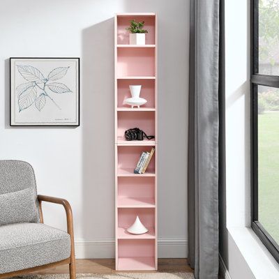 a living room with a chair and book shelf