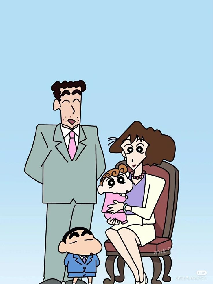 a man in a suit and tie standing next to a woman holding a baby while sitting on a chair