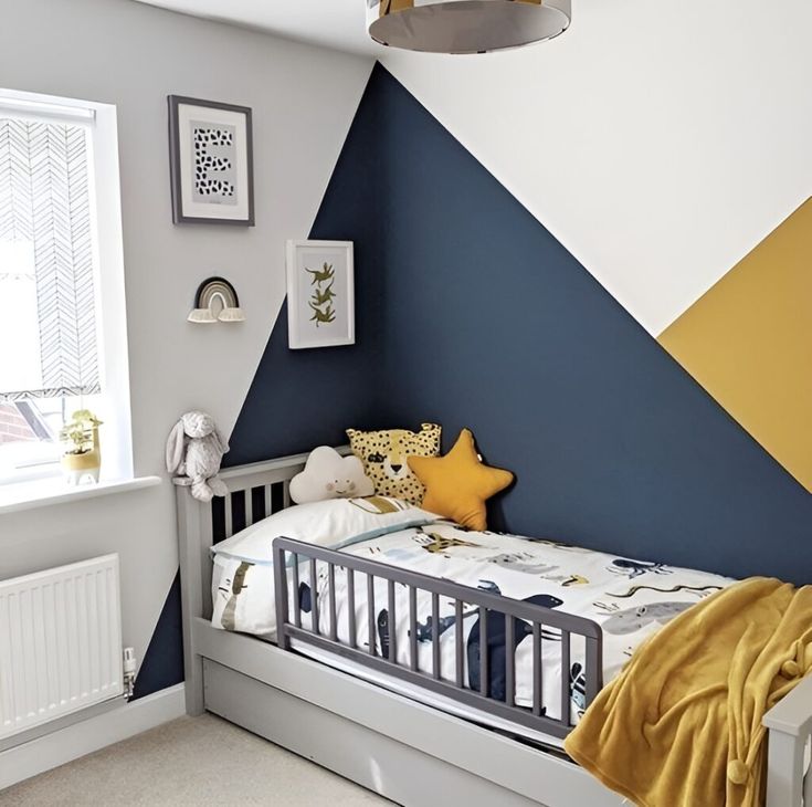 a small child's bed in a room with blue, yellow and white walls