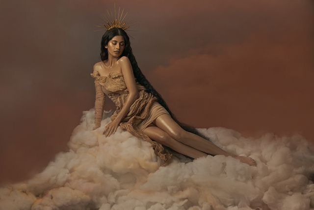 a woman sitting on top of a pile of clouds