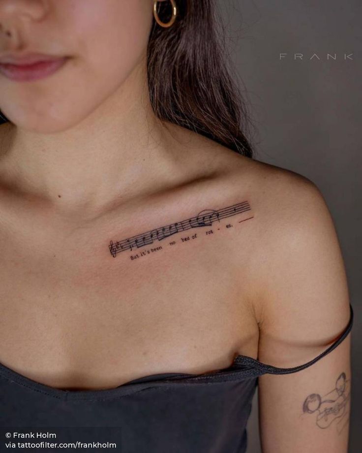 a woman with a tattoo on her shoulder