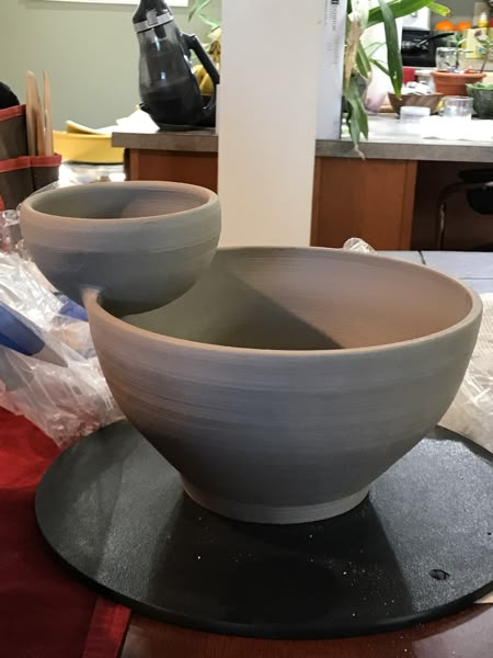 two large bowls sitting on top of a table