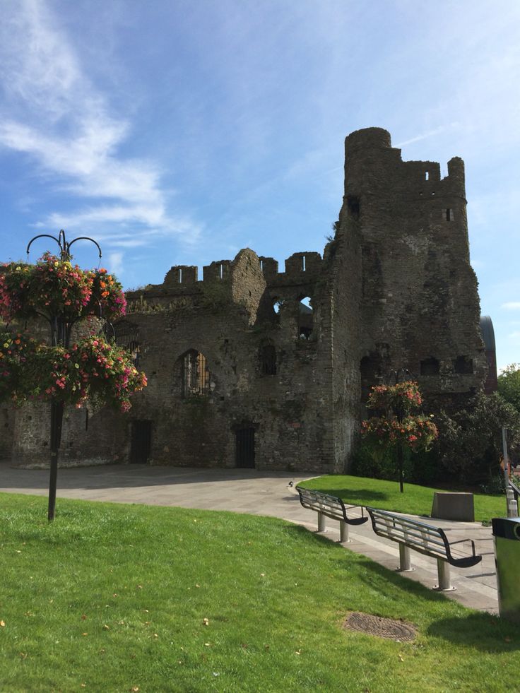 an old castle with a bench in front of it