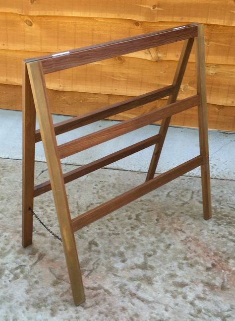 a wooden chair sitting on top of a carpeted floor