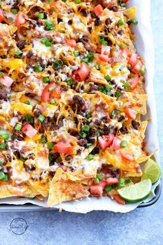 a casserole dish filled with nachos and cheese