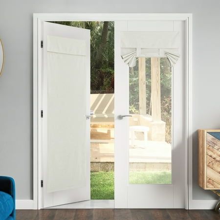 an open white door in a room with wooden flooring and blue chair next to it