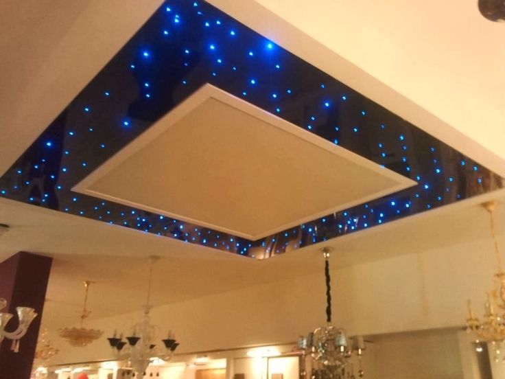 the ceiling is decorated with blue lights and chandelier hanging from it's sides