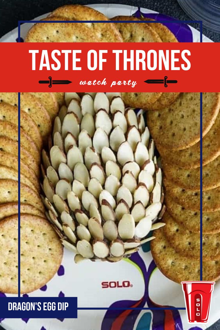 a white plate topped with crackers next to a red and blue sign that says taste of thrones