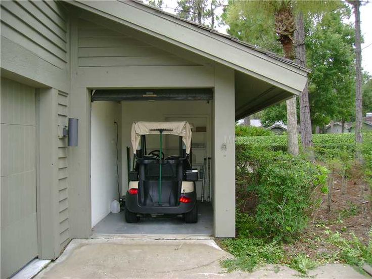 a car is parked in the garage with it's doors open