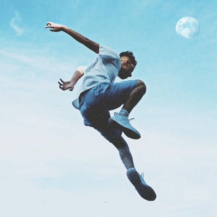 a man jumping in the air with a skateboard on his feet and one foot up