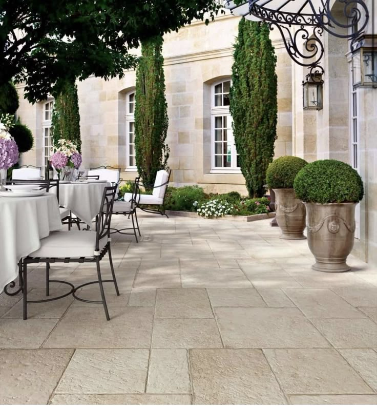 an outdoor dining area with tables and chairs