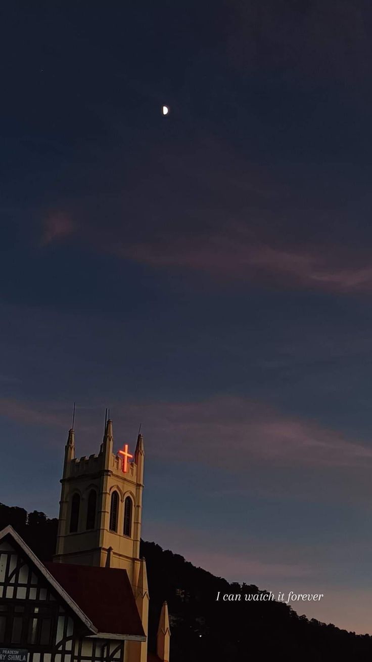 the moon is setting over a church and steeple