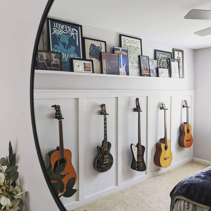 there are guitars hanging on the wall in this bedroom