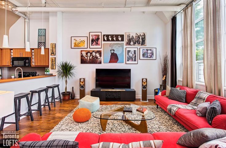 a living room filled with furniture and pictures on the wall