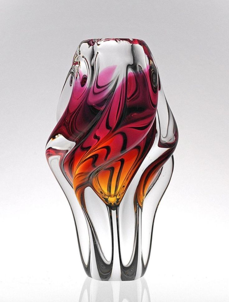 a colorful glass vase sitting on top of a table