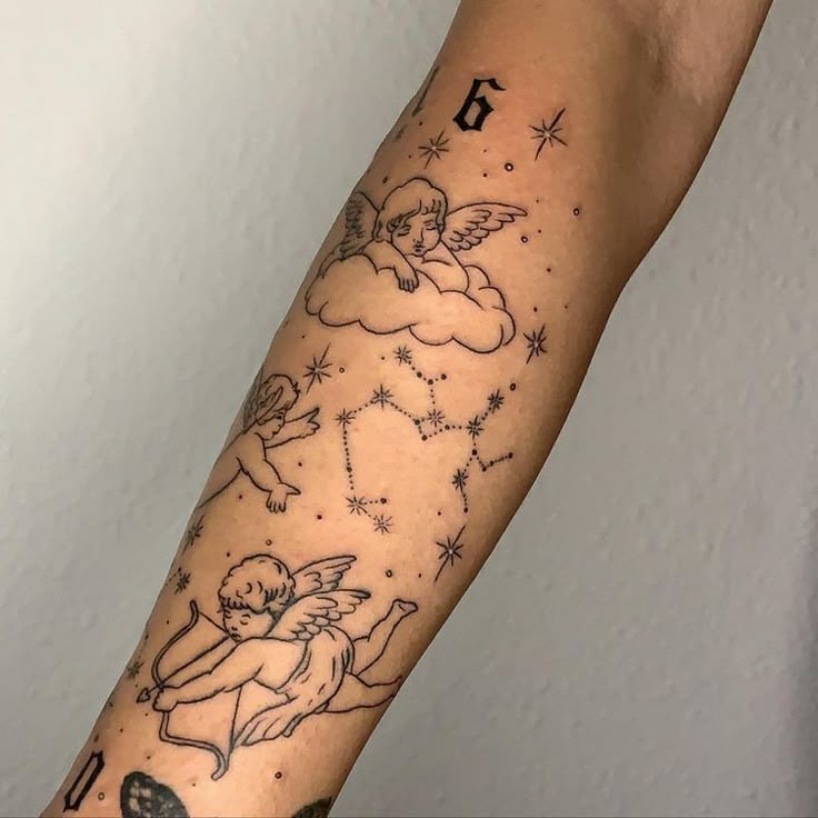 an arm with some tattoos on it and stars in the sky behind it, as well as two cherubs