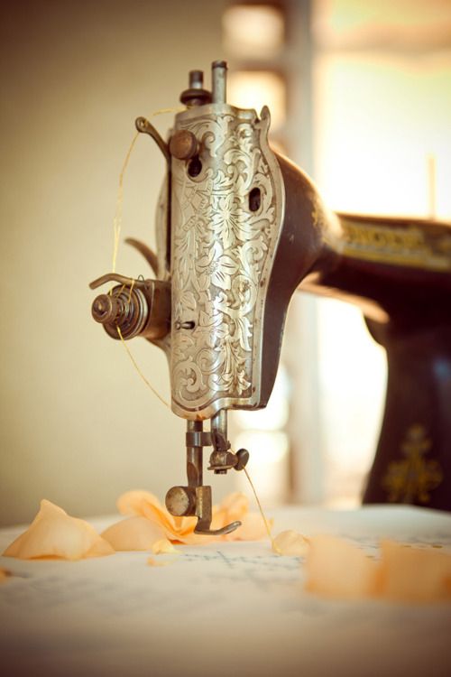 an old sewing machine sitting on top of a table