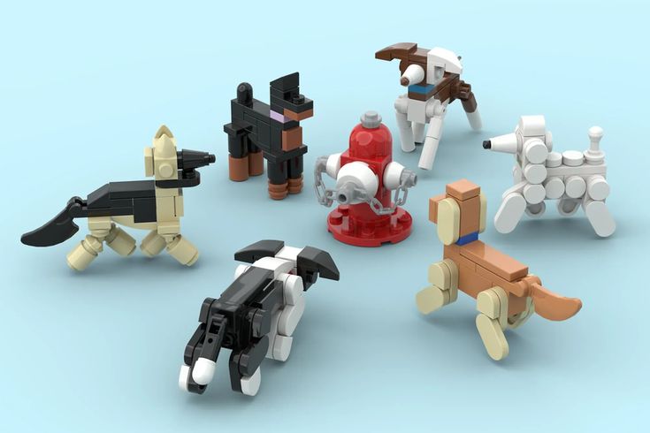 a group of lego dogs sitting on top of a blue floor next to each other