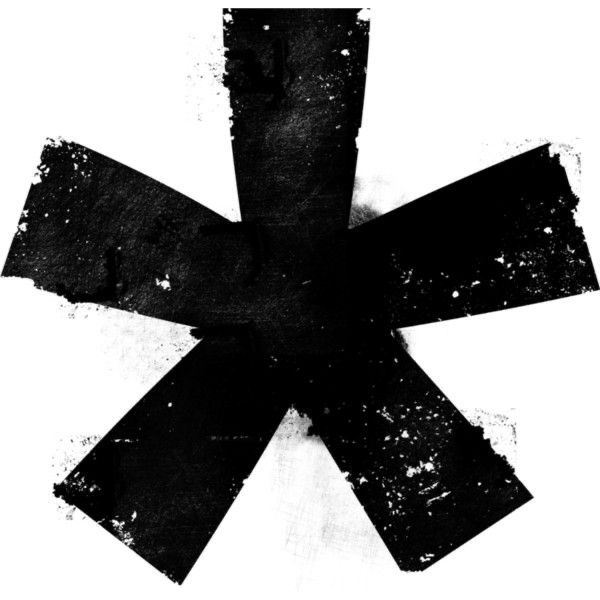 an artistic black and white image of a cross with paint splatters on it