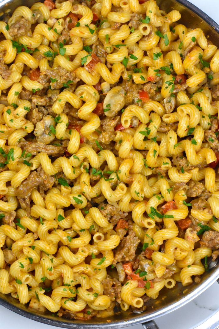 a pan filled with macaroni and cheese on top of a stove