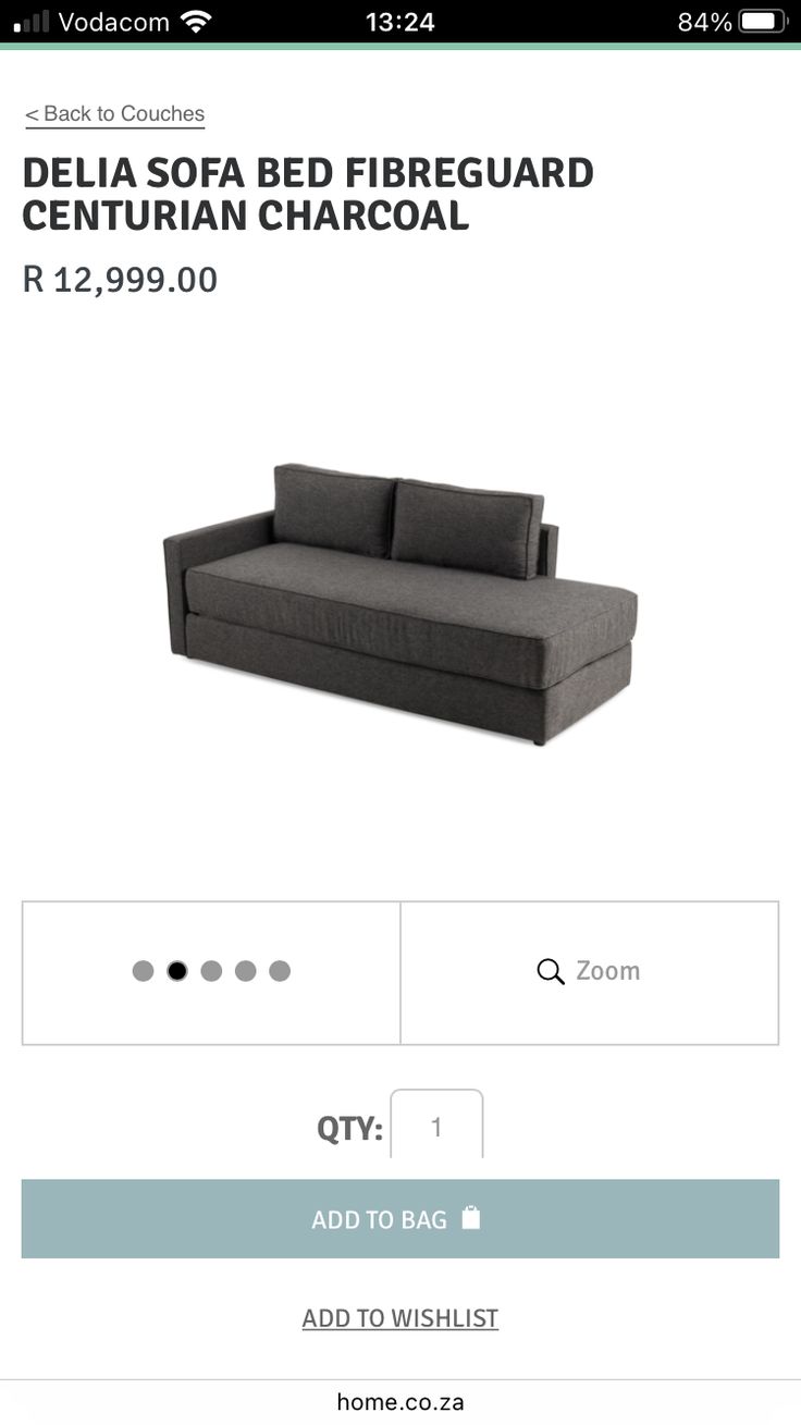 a black couch sitting on top of a white floor next to a sign that reads delta sofa