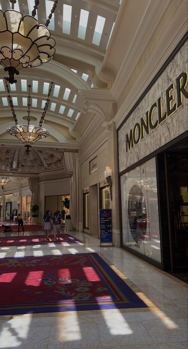 the inside of a shopping mall with people walking around