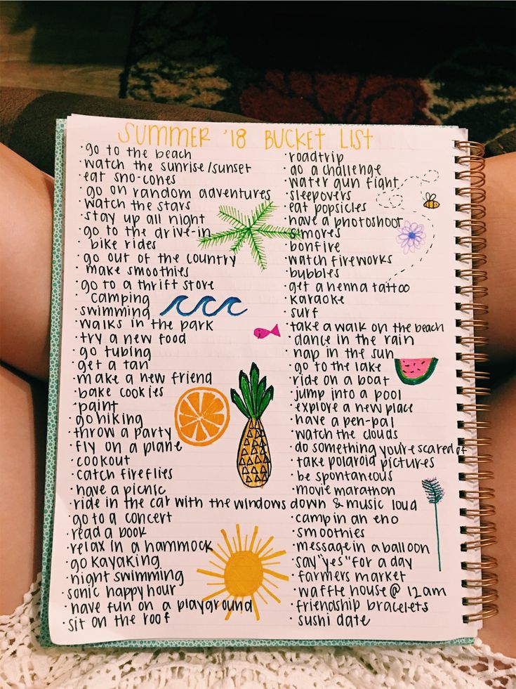 someone is holding up a notebook with some writing on the pages and an image of pineapples