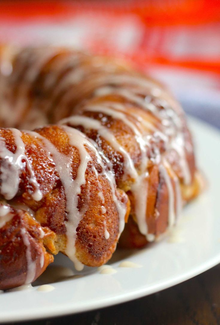 a bundt cake with icing on a white plate