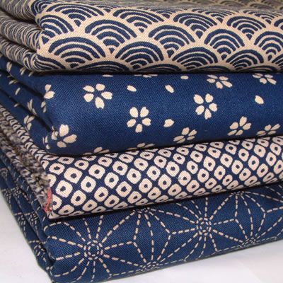 four different types of fabric stacked on top of each other in blue and beige colors