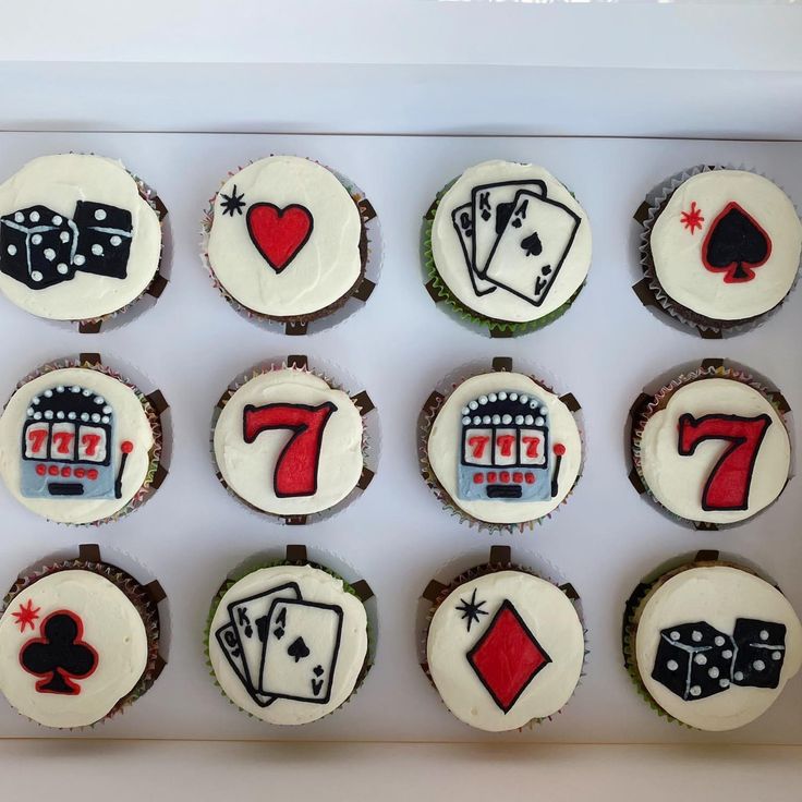 cupcakes decorated with playing cards and numbers are arranged in a box on top of each other