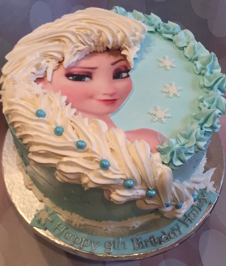 a frozen princess birthday cake with frosting on it