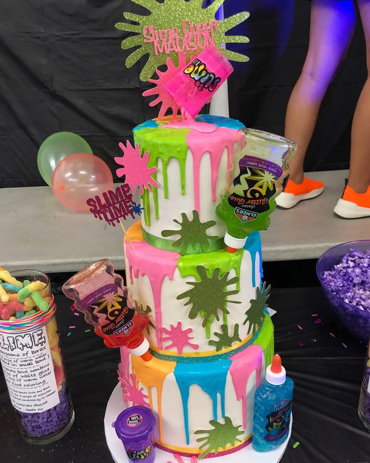 a multi - tiered cake is decorated with neon colors