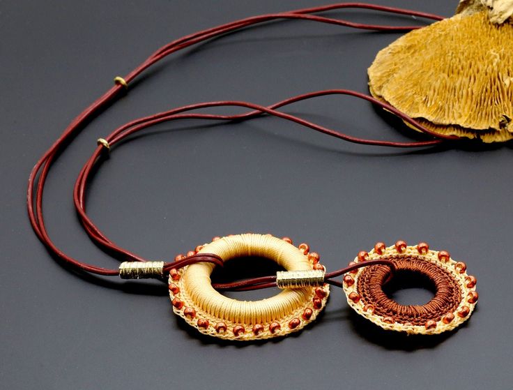 This special ethnic necklace is perfect for you and a gift for those who like to dress in boho ethnic and casual style. This jewelry combines two classic and beautiful colors - yellow-orange and light brown colores.  The necklace is handmade, crochet with S-Lon bead cord (BEAD SMITH) on a wood circle, and decorated with wine Bordo Japanese Miyuki seed beads in two rings pendant. Measurements: Total length: 36.6" (93 cm) Big pendant height and width: 2.5" (6.35 cm) Small pendant height and width: Artisan Brown Jewelry With Large Pendant, Yellow Bohemian Jewelry For The Beach, Yellow Bohemian Jewelry For Beach, Bohemian Choker Necklace With Adjustable Chain, Bohemian Brown Necklace With Adjustable Length, Brown Necklace With Adjustable Cord For Festivals, Handmade Yellow Jewelry For The Beach, Handmade Yellow Jewelry For Beach, Brown Jewelry With Adjustable Chain For Festival