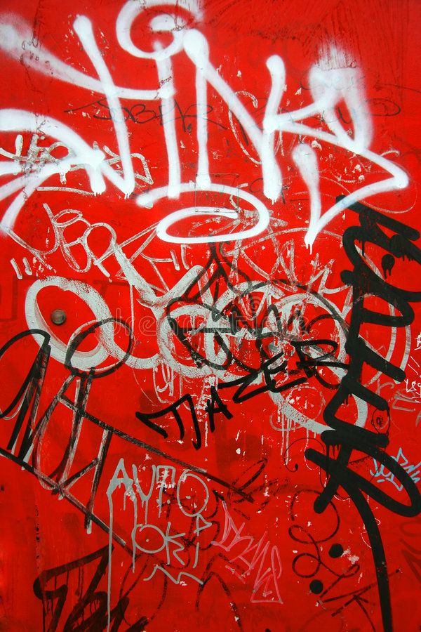 graffiti on the side of a red wall