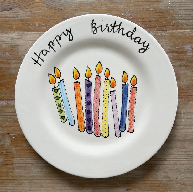 a plate with candles on it that says happy birthday