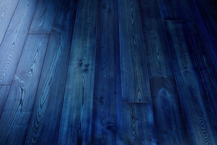 a wooden floor with blue paint on it