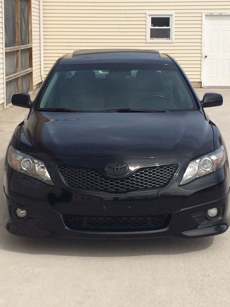 a black car parked in front of a house