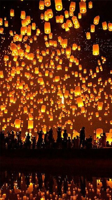 many lanterns floating in the air at night