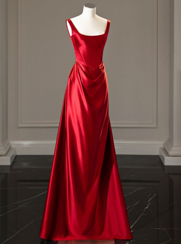 Fantasia of elegance defines this resplendent red prom dress, designed for a night where every moment is a cherished memory in the making. The satin sheen of the fabric catches every light, creating a lustrous backdrop for an evening of dancing and celebration. This dress boasts a tailored fit that highlights the natural grace of the wearer, with a bodice that elegantly frames the decolletage and transitions into a beautifully draped skirt. The skirt itself, a masterpiece of design, drapes in such a way that it enhances the silhouette, creating an effect of both volume and fluidity. The gown's striking color promises to turn heads, ensuring the wearer feels like the protagonist of her own enchanted evening. For the discerning prom attendee, this dress is more than an outfit; it's a canvas 1900s Formal Dress, Old Hollywood Glam Red Dress, Red Prom Dress Lace Up Back, Red Satin Long Dress, Light Red Wedding Dress, Red Silk Dress Long Prom, Red Dresses Long Elegant, Satin Floor Length Dress, Deep Red Dress Formal