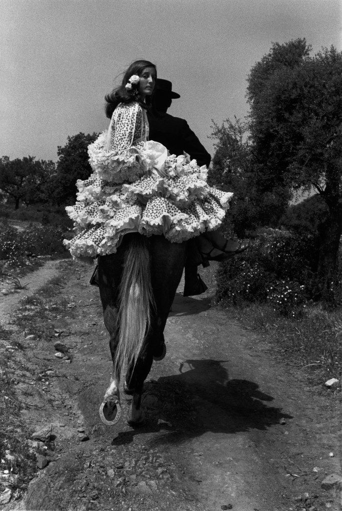 a woman riding on the back of a horse wearing a dress made of crochet