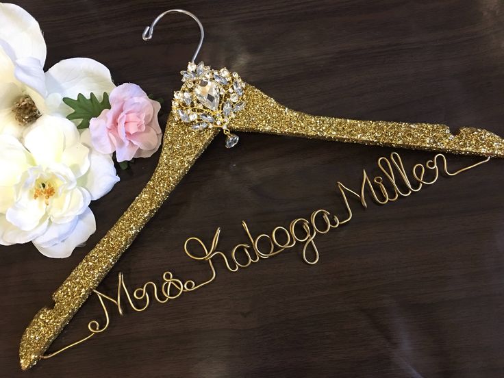 a gold wedding hanger with flowers on it