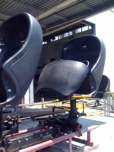 two large black boats sitting on top of a conveyor belt