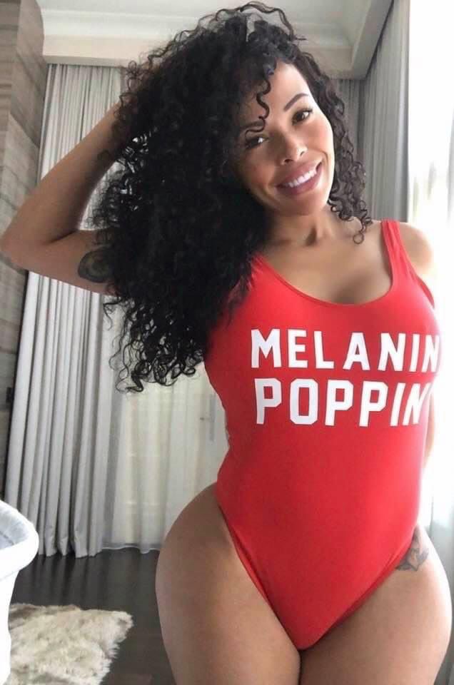 a woman in a red one piece swimsuit with the words melanin poppin on it