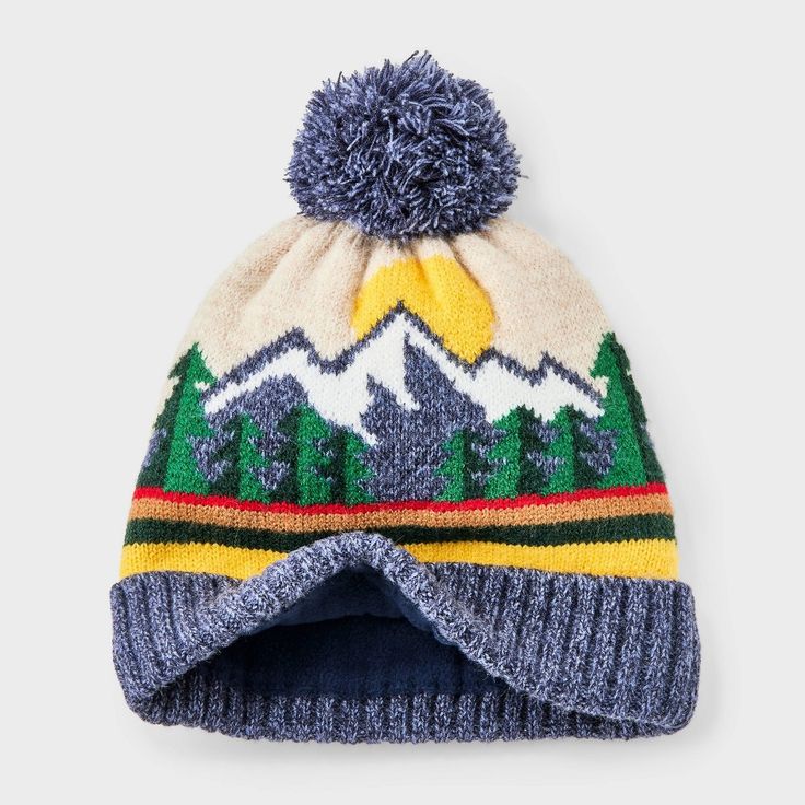 a knitted hat with mountains and trees on the front, in multicolored wool