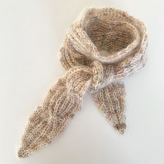 a knitted scarf on a white surface