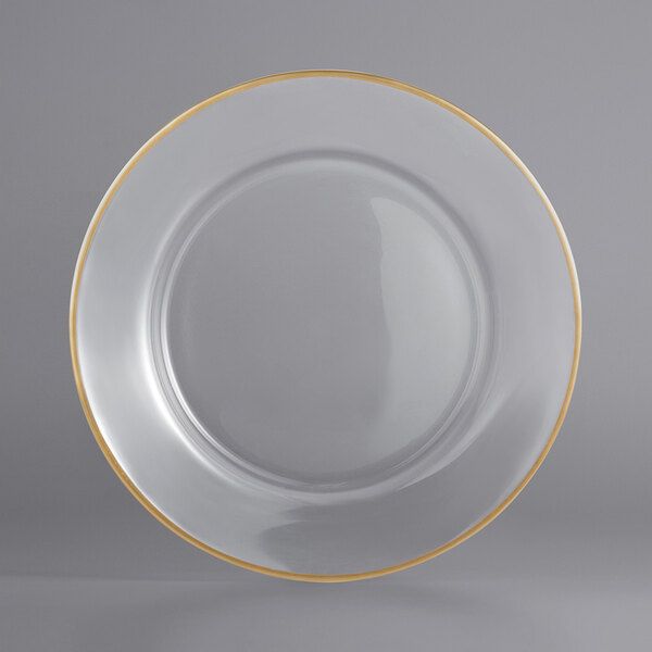 an empty white plate with gold trim around the edge on a gray background, ready to be used as a serving platter