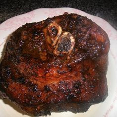 a piece of meat sitting on top of a white plate